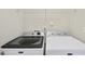 Laundry room features a modern Maytag washer and dryer set against white walls at 4353 Sugarbend Way, Raleigh, NC 27606