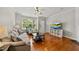 Cozy living room featuring hardwood floors, neutral paint, and abundant natural light at 4353 Sugarbend Way, Raleigh, NC 27606
