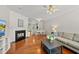 Bright living room features a fireplace, hardwood floors, and neutral decor at 4353 Sugarbend Way, Raleigh, NC 27606