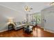 Warm and inviting living room features hardwood floors, neutral paint, and large windows at 4353 Sugarbend Way, Raleigh, NC 27606