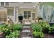 Charming patio with an outdoor grill, a cozy seating area, string lights, and manicured garden at 4353 Sugarbend Way, Raleigh, NC 27606