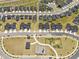 Expansive aerial view of a residential neighborhood featuring well-maintained homes, community parks, and landscaped streets at 445 Sturgeon St, Smithfield, NC 27577