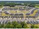 Expansive aerial view showcasing a well-planned community with numerous homes, green spaces, and winding roads at 445 Sturgeon St, Smithfield, NC 27577