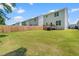 Expansive backyard with well-maintained lawn, rear view of white house with deck at 445 Sturgeon St, Smithfield, NC 27577