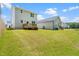 Large grassy backyard offers ample outdoor space; view of back of houses at 445 Sturgeon St, Smithfield, NC 27577
