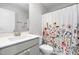 Bathroom features a white vanity with grey cabinets and a floral shower curtain at 445 Sturgeon St, Smithfield, NC 27577