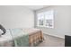 Bedroom featuring a colorful quilt and view from window; carpet is neutral at 445 Sturgeon St, Smithfield, NC 27577