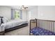 Neutral bedroom with a crib, a comfortable queen bed, and a large window with natural light at 445 Sturgeon St, Smithfield, NC 27577