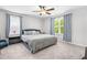 Well-lit bedroom featuring soft carpet, neutral decor, and large windows with bright natural light at 445 Sturgeon St, Smithfield, NC 27577