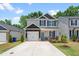 Charming two-story home with a well-manicured lawn, dark shutters, and a driveway at 445 Sturgeon St, Smithfield, NC 27577