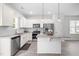 Well-lit kitchen features a stainless steel refrigerator, dishwasher, oven and a granite-topped island at 445 Sturgeon St, Smithfield, NC 27577