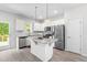 Modern kitchen with stainless steel appliances, a granite-topped island, and white cabinetry at 445 Sturgeon St, Smithfield, NC 27577