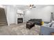 Inviting living room with a fireplace, built-in shelving, comfortable seating, and a ceiling fan at 445 Sturgeon St, Smithfield, NC 27577
