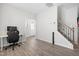 Bright living room featuring wood floors, stairs, and a view of the front door entrance at 445 Sturgeon St, Smithfield, NC 27577