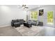 Cozy living room with a ceiling fan, large window, comfortable sofas, and stylish decor at 445 Sturgeon St, Smithfield, NC 27577