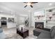 Open-concept living room and kitchen area with modern appliances, a fireplace, and a staircase at 445 Sturgeon St, Smithfield, NC 27577