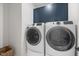 Modern laundry room with navy cabinets and front loading washer and dryer at 4713 Mint Leaf Ln, Raleigh, NC 27612