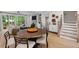 Inviting living and dining area with hardwood floors, fireplace, and a large window with natural light at 4713 Mint Leaf Ln, Raleigh, NC 27612