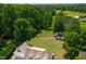 Expansive lot featuring mature trees, lawn, fire pit, guest house and home at 4720 Cedarfield Dr, Raleigh, NC 27606