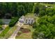 Charming home featuring a large, green yard, landscaping, and a winding driveway at 4720 Cedarfield Dr, Raleigh, NC 27606
