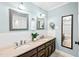 Well lit bathroom features double sinks with framed mirrors, tiled backsplash, and a hardwood floor at 4720 Cedarfield Dr, Raleigh, NC 27606