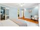 Tranquil bedroom with hardwood floors, a ceiling fan, and an en-suite bathroom, closet, and windows at 4720 Cedarfield Dr, Raleigh, NC 27606