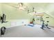 Upstairs exercise room with light-green walls, multiple ceiling fans and an exercise bike at 4720 Cedarfield Dr, Raleigh, NC 27606