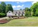 Charming home featuring a landscaped front yard, dormer windows, and attached garage at 4720 Cedarfield Dr, Raleigh, NC 27606