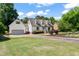 View of the home's exterior featuring a long driveway and attached garage at 4720 Cedarfield Dr, Raleigh, NC 27606