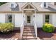Charming front door entrance with brick steps and manicured landscaping at 4720 Cedarfield Dr, Raleigh, NC 27606