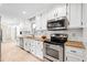 Well-lit kitchen with stainless steel appliances, granite countertops, and white subway tile backsplash at 4720 Cedarfield Dr, Raleigh, NC 27606