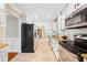 Galley kitchen features stainless steel appliances, white cabinets and backsplash with granite countertops at 4720 Cedarfield Dr, Raleigh, NC 27606