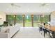 Bright sunroom with ceiling fans, tile flooring, large windows, and a view of the expansive yard at 4720 Cedarfield Dr, Raleigh, NC 27606