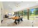 Open sunroom with dining and lounge spaces with windows overlooking the large yard with mature trees at 4720 Cedarfield Dr, Raleigh, NC 27606