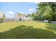 Home's spacious, fenced backyard, ideal for recreation and relaxation, with mature trees and outdoor shed at 4805 Castle Crest Ct, Raleigh, NC 27616