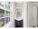 Chic half-bath featuring modern fixtures, a sleek vanity, and a window for natural light at 4805 Castle Crest Ct, Raleigh, NC 27616