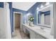Bathroom featuring double sink vanity, tiled floors, and natural light at 4805 Castle Crest Ct, Raleigh, NC 27616