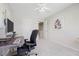 Bright bedroom featuring a ceiling fan, carpet, and a work desk setup for study or work at 4805 Castle Crest Ct, Raleigh, NC 27616