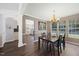 Dining room with hardwood floors, a chandelier, and natural light coming from the windows at 4805 Castle Crest Ct, Raleigh, NC 27616