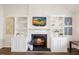 Living room fireplace with built-ins and a mounted tv at 4805 Castle Crest Ct, Raleigh, NC 27616