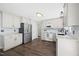 Clean, white kitchen with stainless steel appliances and sleek finishes at 4805 Castle Crest Ct, Raleigh, NC 27616