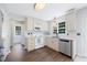 Charming kitchen with stainless steel appliances, white cabinetry, and hardwood floors at 4805 Castle Crest Ct, Raleigh, NC 27616