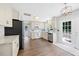 Cozy kitchen featuring stainless steel appliances, white cabinetry, and access to the backyard at 4805 Castle Crest Ct, Raleigh, NC 27616