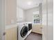 Convenient laundry room featuring modern washer and dryer units and ample storage space at 4805 Castle Crest Ct, Raleigh, NC 27616