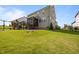 Backyard view showing a grey home with a covered deck and wooden playset at 525 Marion Hills Way, Knightdale, NC 27545