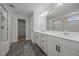 Bathroom featuring double vanities, a glass-enclosed shower, and tile flooring at 525 Marion Hills Way, Knightdale, NC 27545