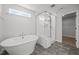 Luxurious bathroom with a soaking tub and separate glass-enclosed shower at 525 Marion Hills Way, Knightdale, NC 27545