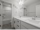 Bright bathroom with double vanity, framed mirror, and shower-tub combo at 525 Marion Hills Way, Knightdale, NC 27545