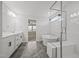Bright bathroom featuring a soaking tub, glass-enclosed shower, double vanity and tiled floors at 525 Marion Hills Way, Knightdale, NC 27545