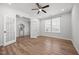 Bright bedroom with hardwood floors, a ceiling fan, a window, and access to a closet for ample storage at 525 Marion Hills Way, Knightdale, NC 27545